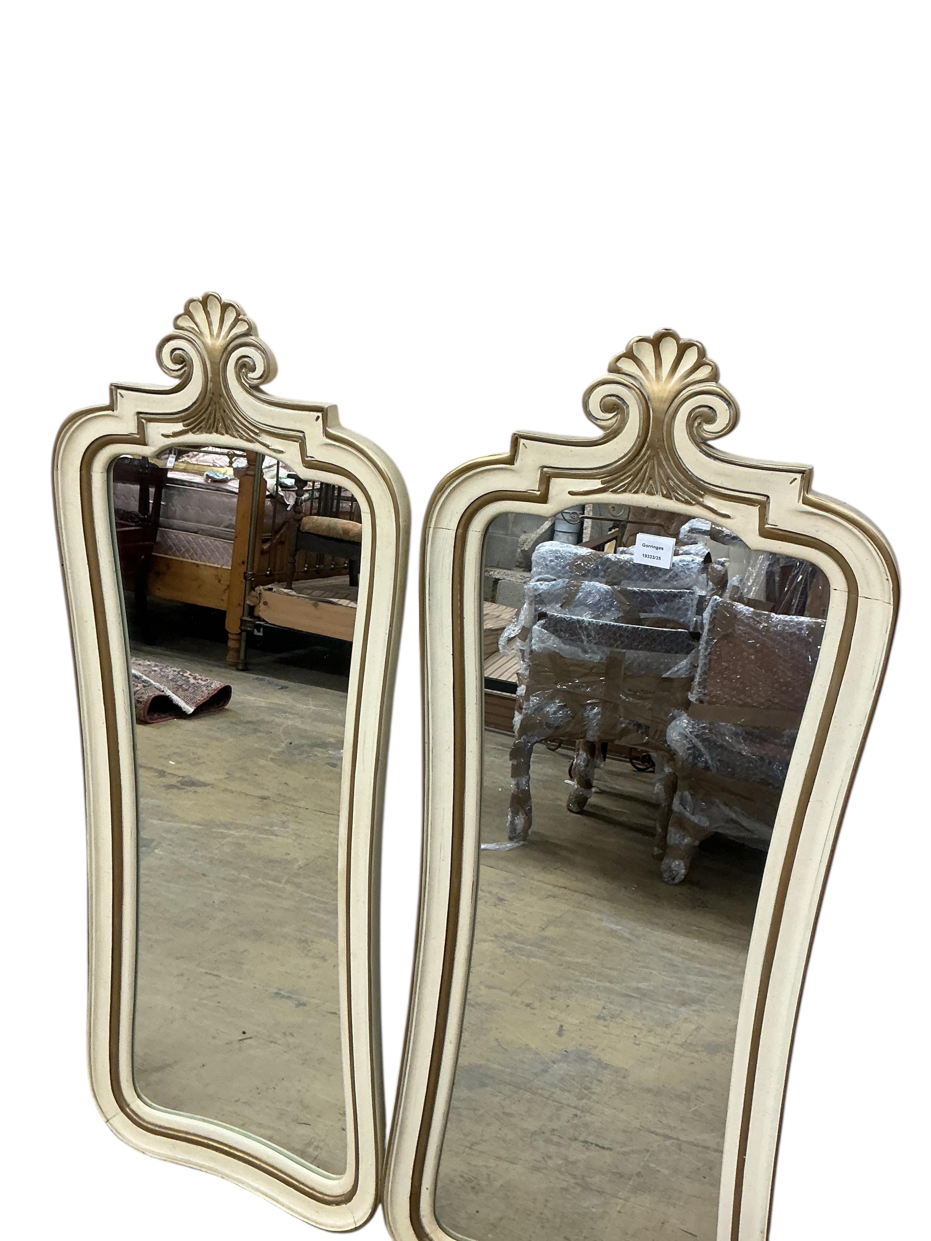 A pair of American white and gilt painted wall mirrors, width 50cm, height 130cm